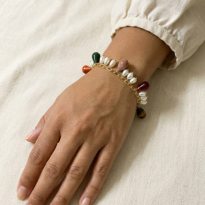 Gold paperclip chain bracelet with multicolour teardrop stone charms in green, orange, mauve, burgundy and tiger eye alternating with clusters of pearls
