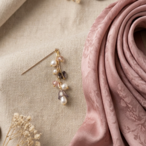 Gold hijab pin with cascading pearl and crystal charms in blush pink and mauve tones with gold bead accents