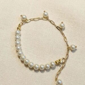 Pearl bracelet with gold paperclip chain extender featuring floating pearl drops and gold bead accents with lobster clasp